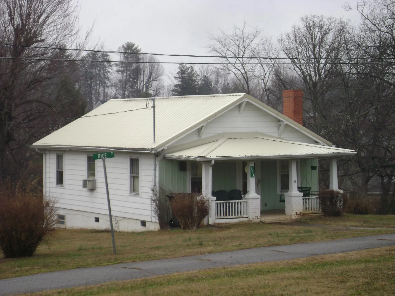 White metal roof on a craftsman bungalow at a street corner in Uniontown