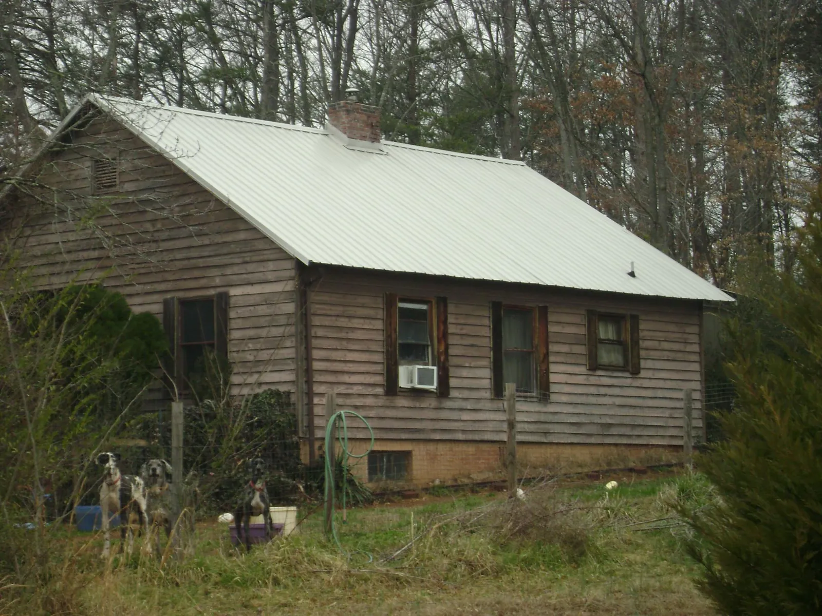 White metal roof on an old wood sided farmhouse, from a Metal Roof Installation job in Uniontown
